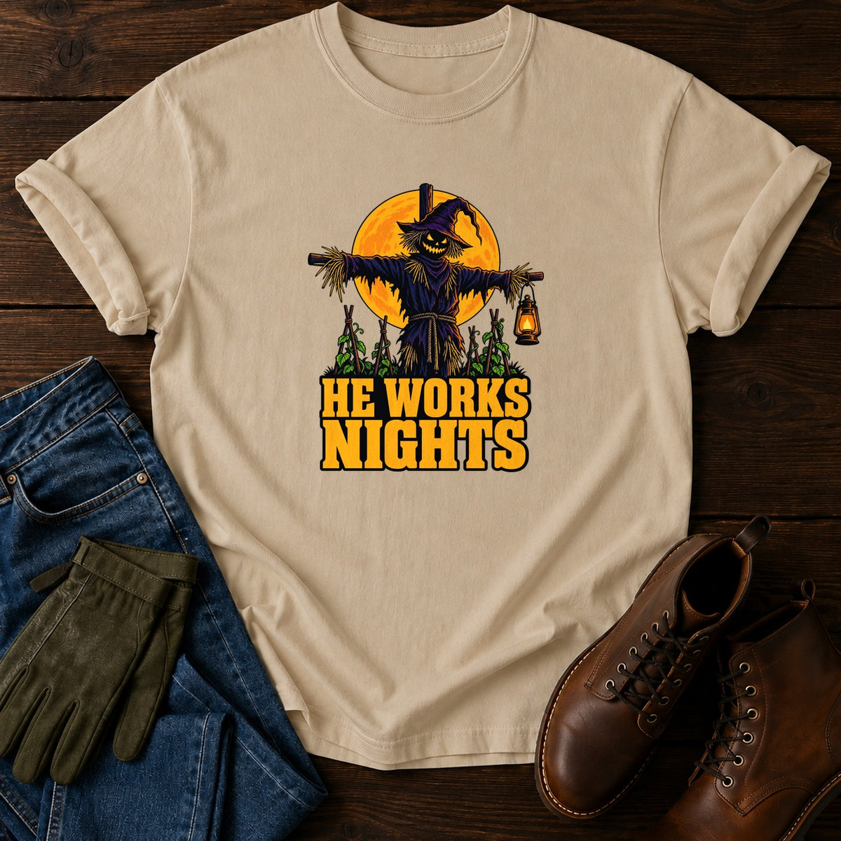 He Works Nights Scarecrow Halloween Garden T-Shirt — Sandstone